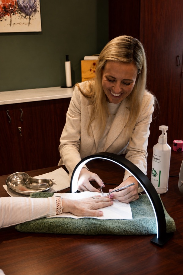 A therapist providing hands-on treatment during a scar management session